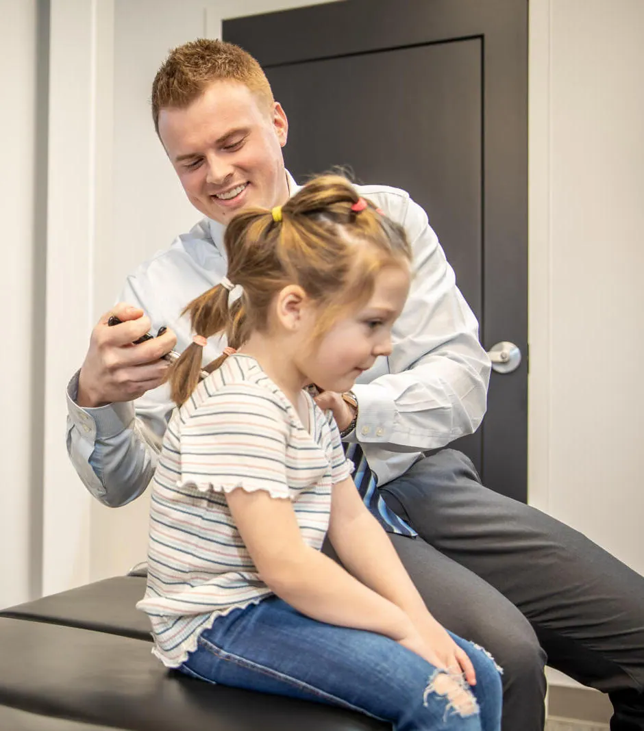 Dr. Andrew Jahner adjusting a young patient