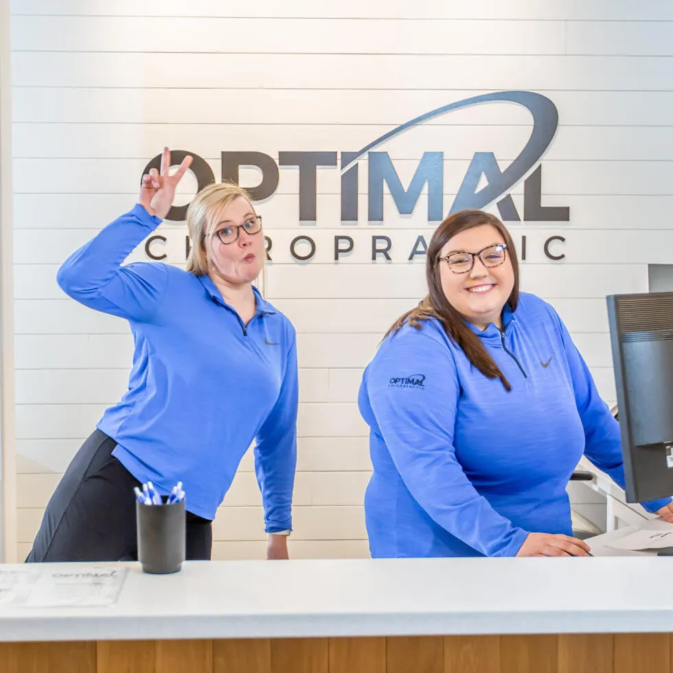 Two Optimal Chiropractic front desk team members at reception