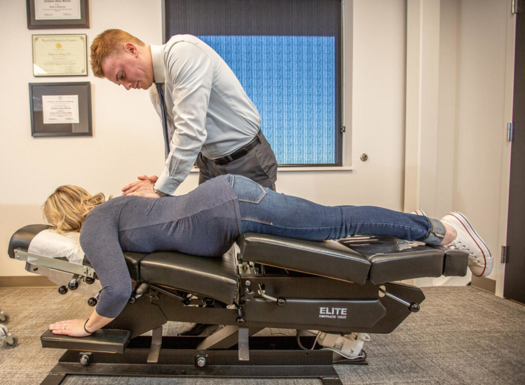 Dr. Andrew Jahne attend to pregnant patient, chiropractor prenatal care