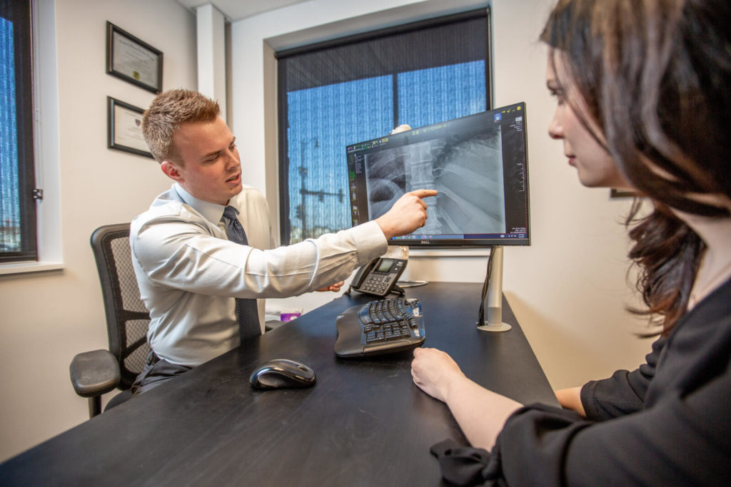Dr. Andrew Jahne showing patients neck pain xray result