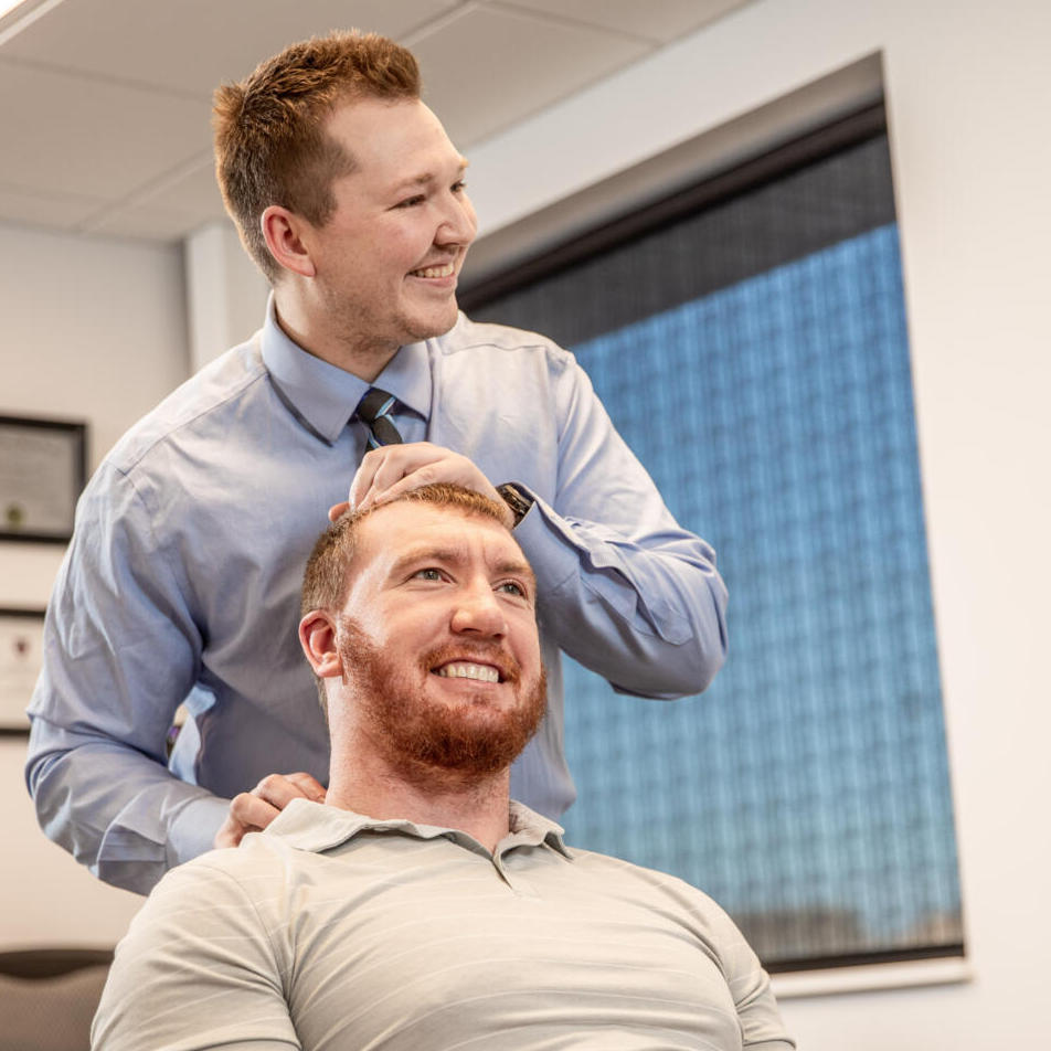 Dr. Nicholas Barney attend patient neck pain treatment
